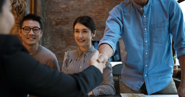 job candidate shakes hiring manager hand